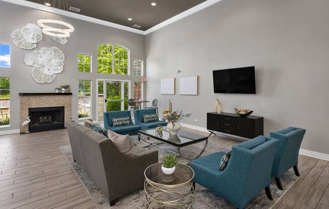 a living room with blue couches and chairs and a fireplace