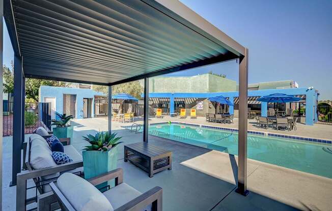 A pool area with a blue tarp covering the pool.