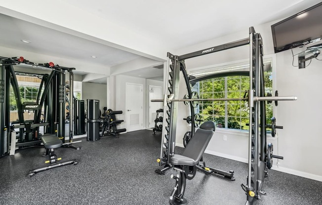 A spacious home gym with a variety of equipment.