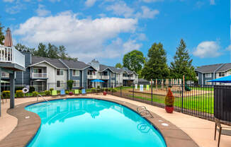 a swimming pool with houses in the background