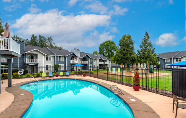 a swimming pool with houses in the background