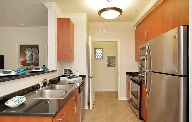 Kitchen with stainless steel appliances; open to living room; door to laundry room