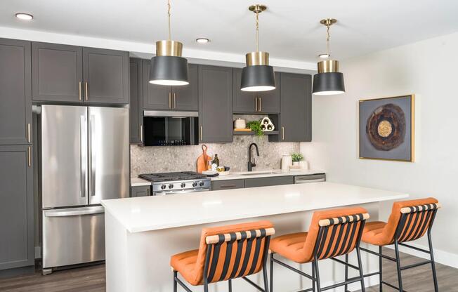 Modern kitchens feature sleek cabinetry, quartz countertops, and stainless steel appliances with designer pendant lighting.