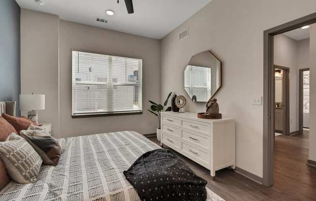 a bedroom with a large bed and a dresser with a mirror  at The Sophia, Venice, FL, 34275