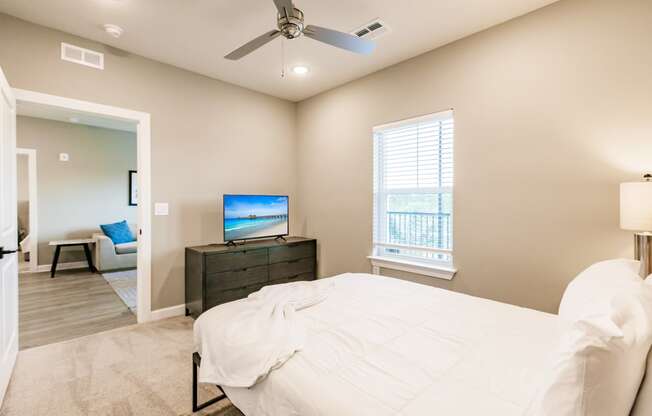 a bedroom with a bed, tv, and dresser at Vantage apartments in cape coral