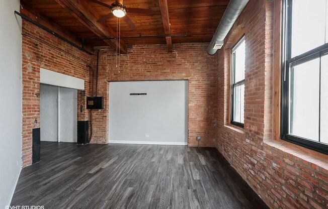Spacious living area with stunning brick wallsriors- at Carriage House Lofts, Illinois, 60605