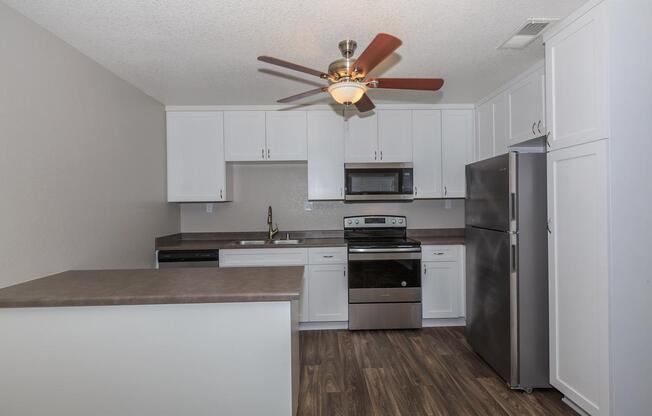 a kitchen with a stove and a refrigerator