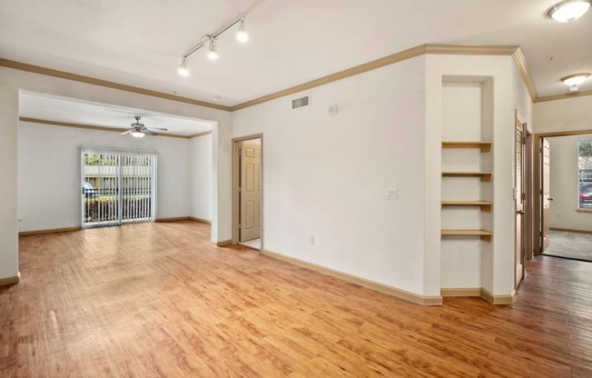 a living room with a hardwood floor and white walls