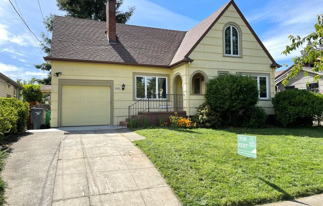 Rose City Park Tudor with Finished Attic/Basement, Attached Garage, Hardwoods, Fenced Backyard