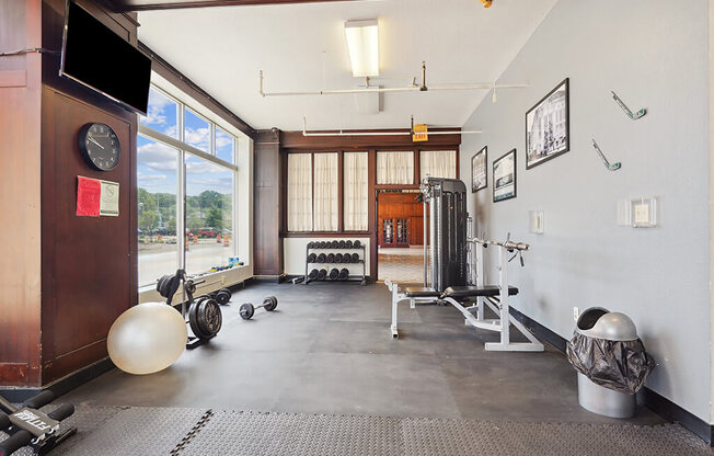 a workout room with weights and a window