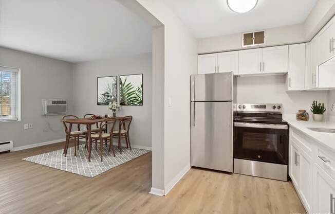 A kitchen with a table and chairs in the middle of the room.