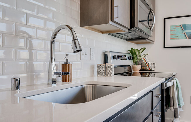 Large kitchen snick with a white brick backsplash