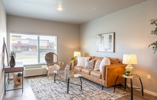 an open living room with a couch and a window