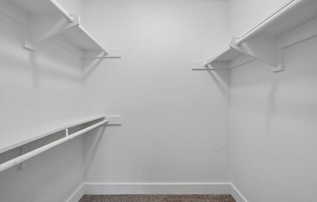 Empty white shelves in a room.