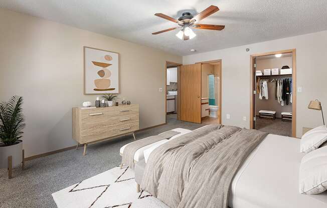 a bedroom with a large bed and a ceiling fan