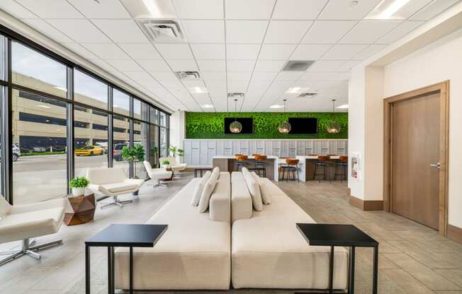 a large lobby with couches and chairs and a table with chairs