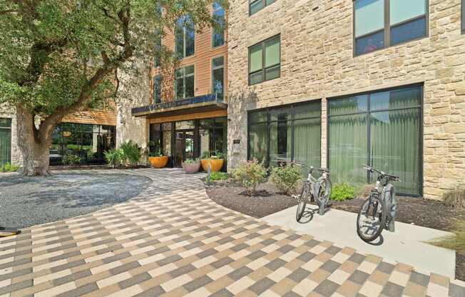 A courtyard with a brick patterned floor and a bicycle.