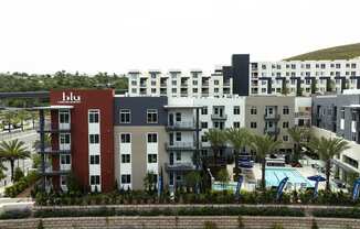 an aerial view of an apartment complex with a swimming pool