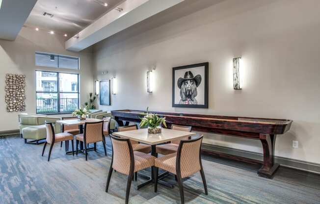 a dining room with tables and chairs and a pool table