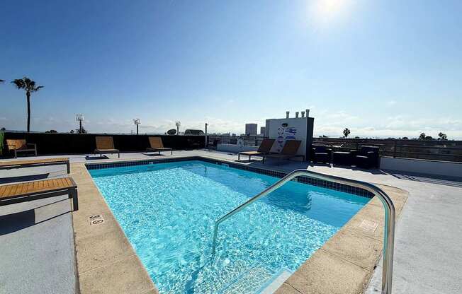 Swimming pool with a sunny sky in the background.