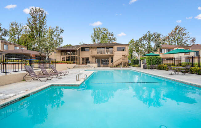 A swimming pool in front of apartment buildings.