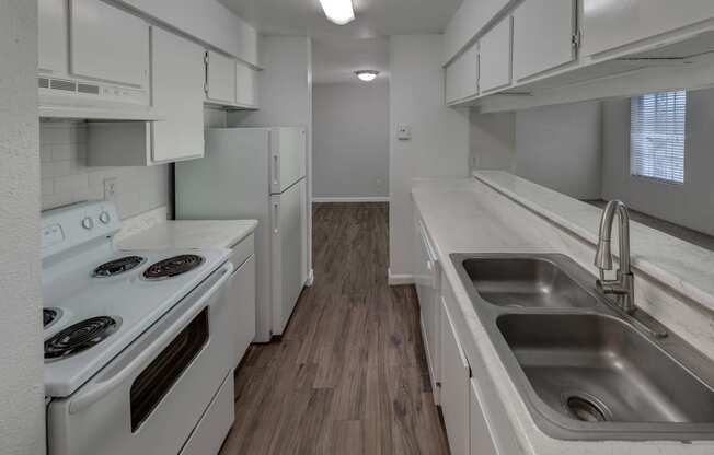 a kitchen with white appliances and white cabinets