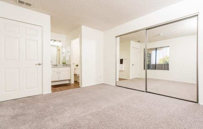 Bedroom with large mirror, closet and sink at Woodbend, Alta Loma, California