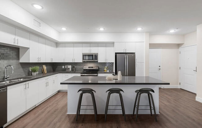 Model kitchen with white cabinetry