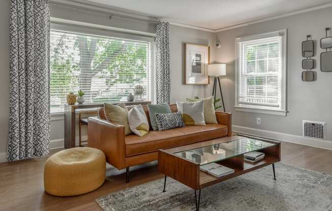 a living room with a leather couch and a coffee table