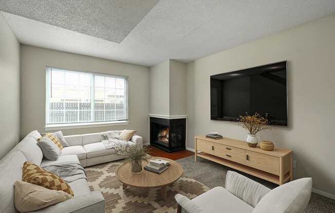 A living room with a fireplace and a television mounted on the wall.