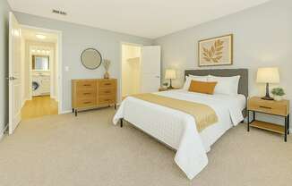 A bedroom with a large bed and a dresser.