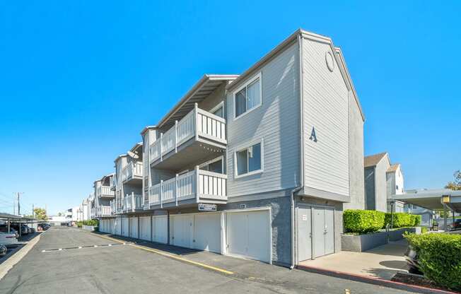 a row of apartment buildings with balconies and garages