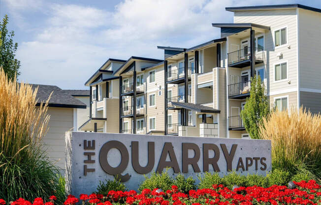 an apartment building with a sign that reads the quarry apts