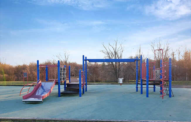 an empty playground with slides and a swing set