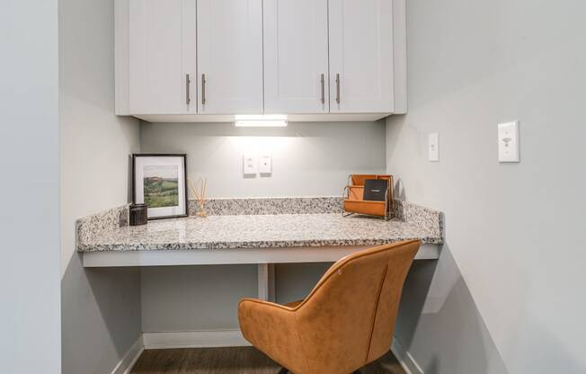 an office with a desk and a chair under a counter