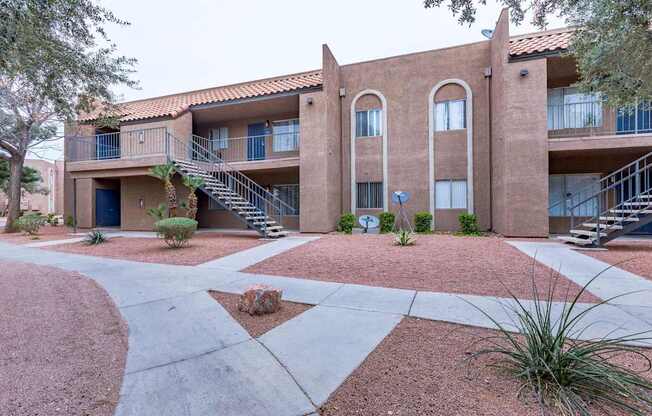 A building with a red tile roof and a staircase leading to the second floor.