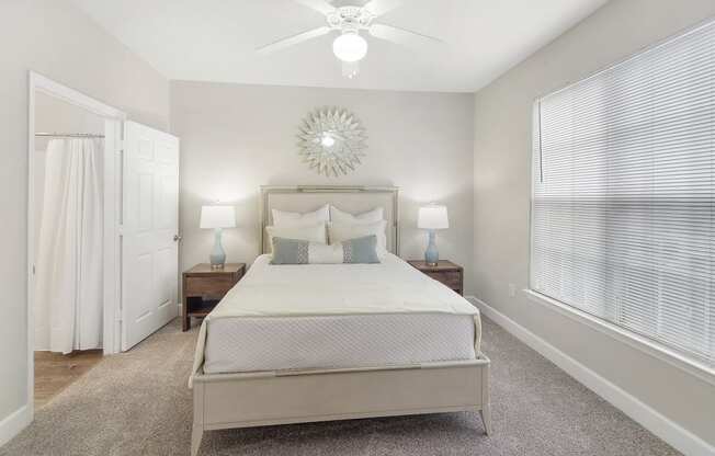 a bedroom with a bed and a ceiling fan at Highlands Apartment Homes, Bartlett, TN, 38135