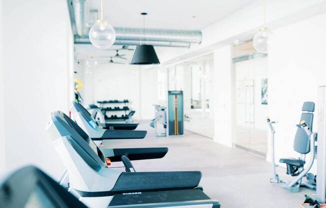 a row of treadmills at the 24-hour fitness center at The Merchant Apartments, Charleston