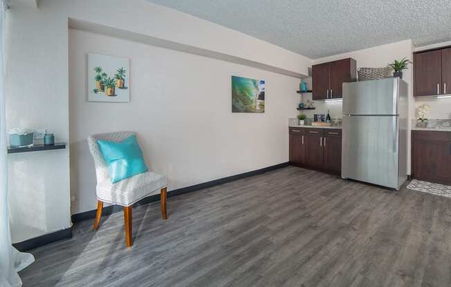 Waikiki Walina Apartments living area with decor and kitchen area with appliances, cabinets, and counters