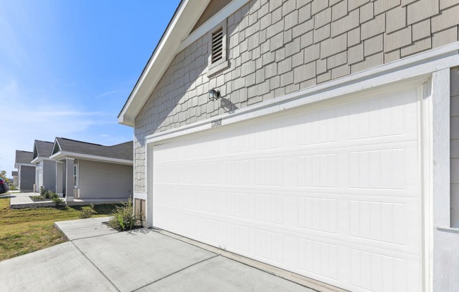 Attached garage of Dogwood home with ample parking space at Beacon at Presidential Heights in Manor, TX