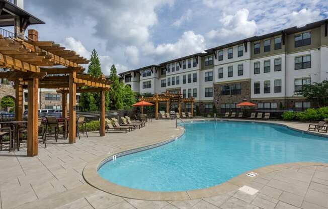 Resort-style Pool with seating at 4700 Colonnade Apartments in Birmingham, AL