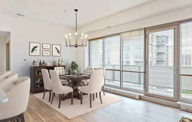 Enjoy the scenic views from the floor-to-ceiling windows in the dining and living area of a 2 bedroom penthouse floor plan at Midtown Crossing Apartments Omaha