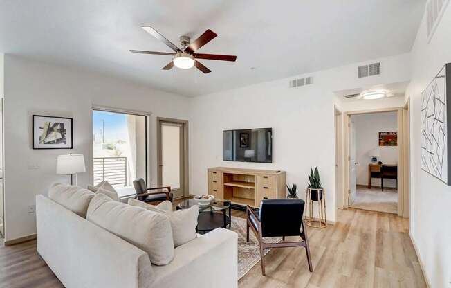 A living room with a white couch and a television.