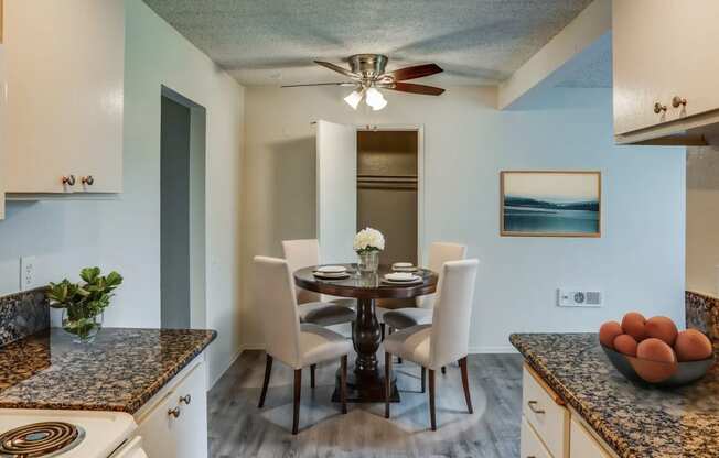 a kitchen and dining room with a table and chairs