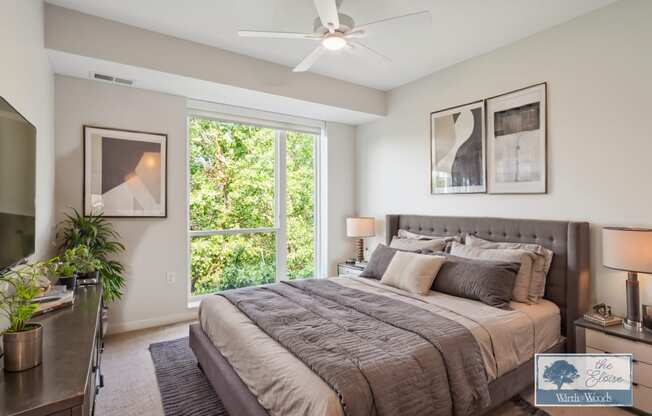 a bedroom with a large bed and a ceiling fan