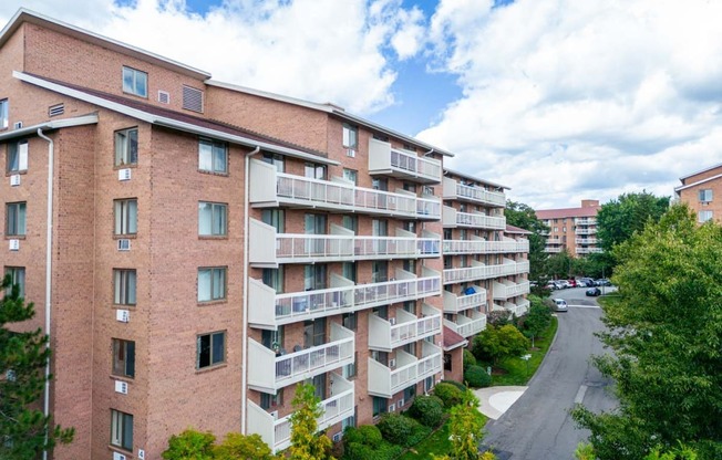 a view of an apartment building with a street in front of it