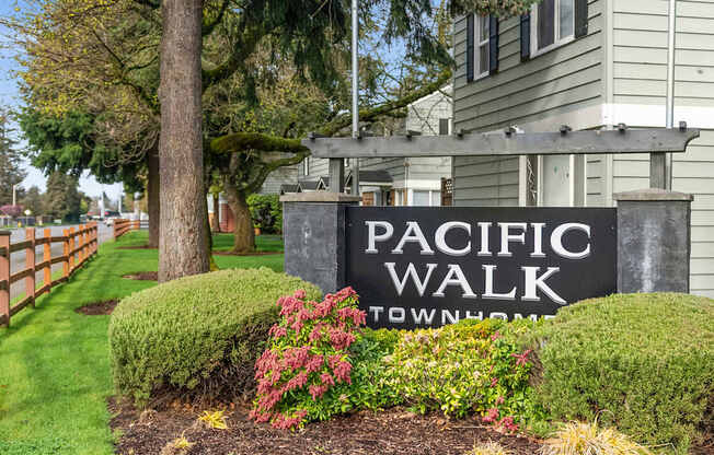 A sign that says Pacific Walk in front of a building.