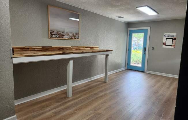 an empty room with a table in the center of it