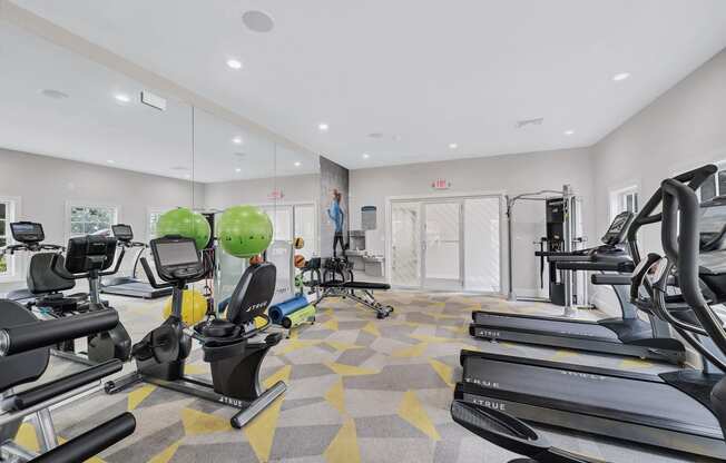 the gym with treadmills and weights at the flats