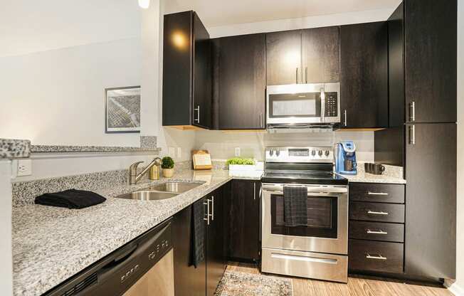 a kitchen with stainless steel appliances and granite counter tops